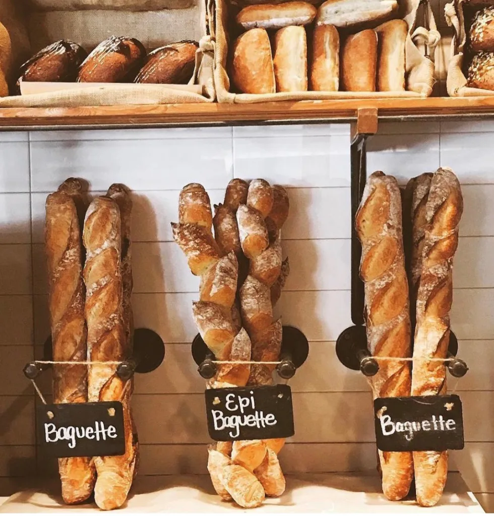 Baguettes and epi baguettes hanging on display with chalkboard price tags