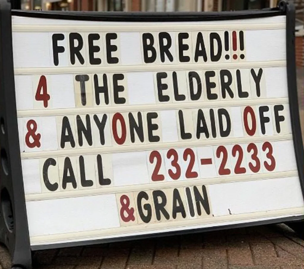 Sign outside &grain offering free bread to the elderly and anyone laid off