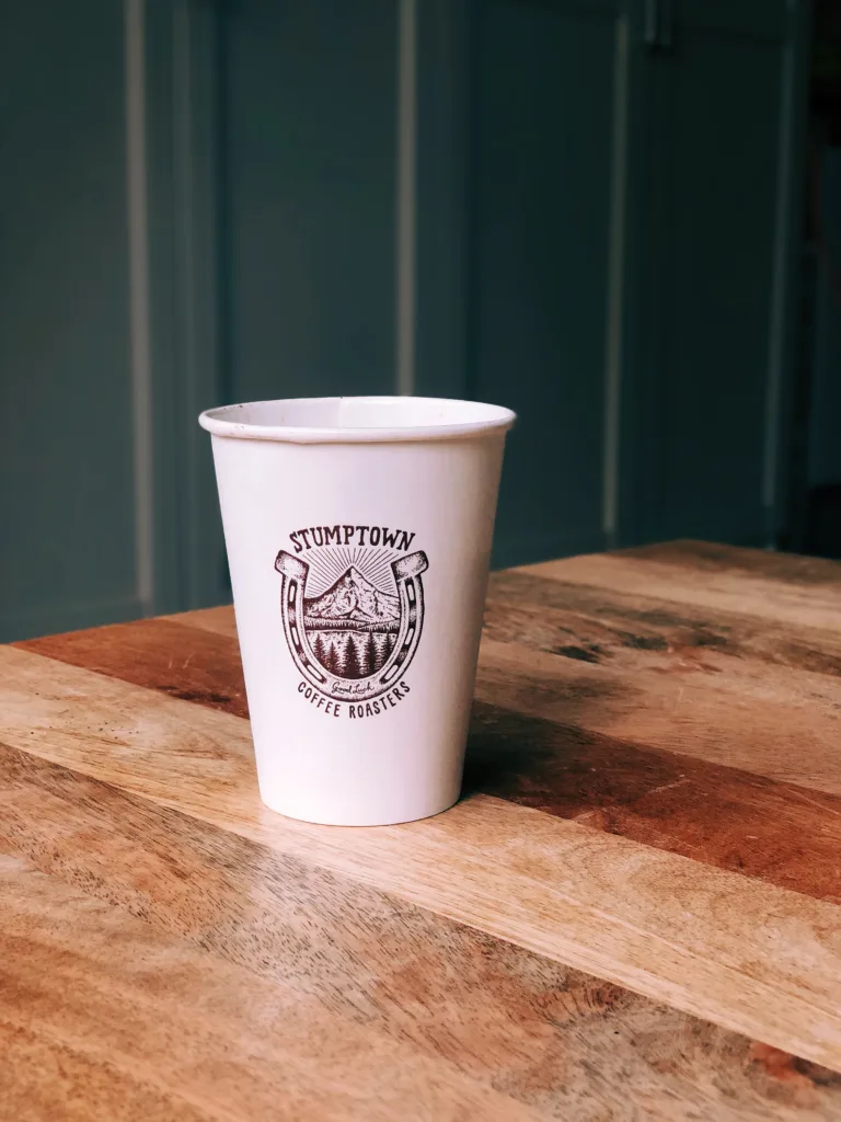 Stumptown Coffee Roasters paper cup on a wooden table